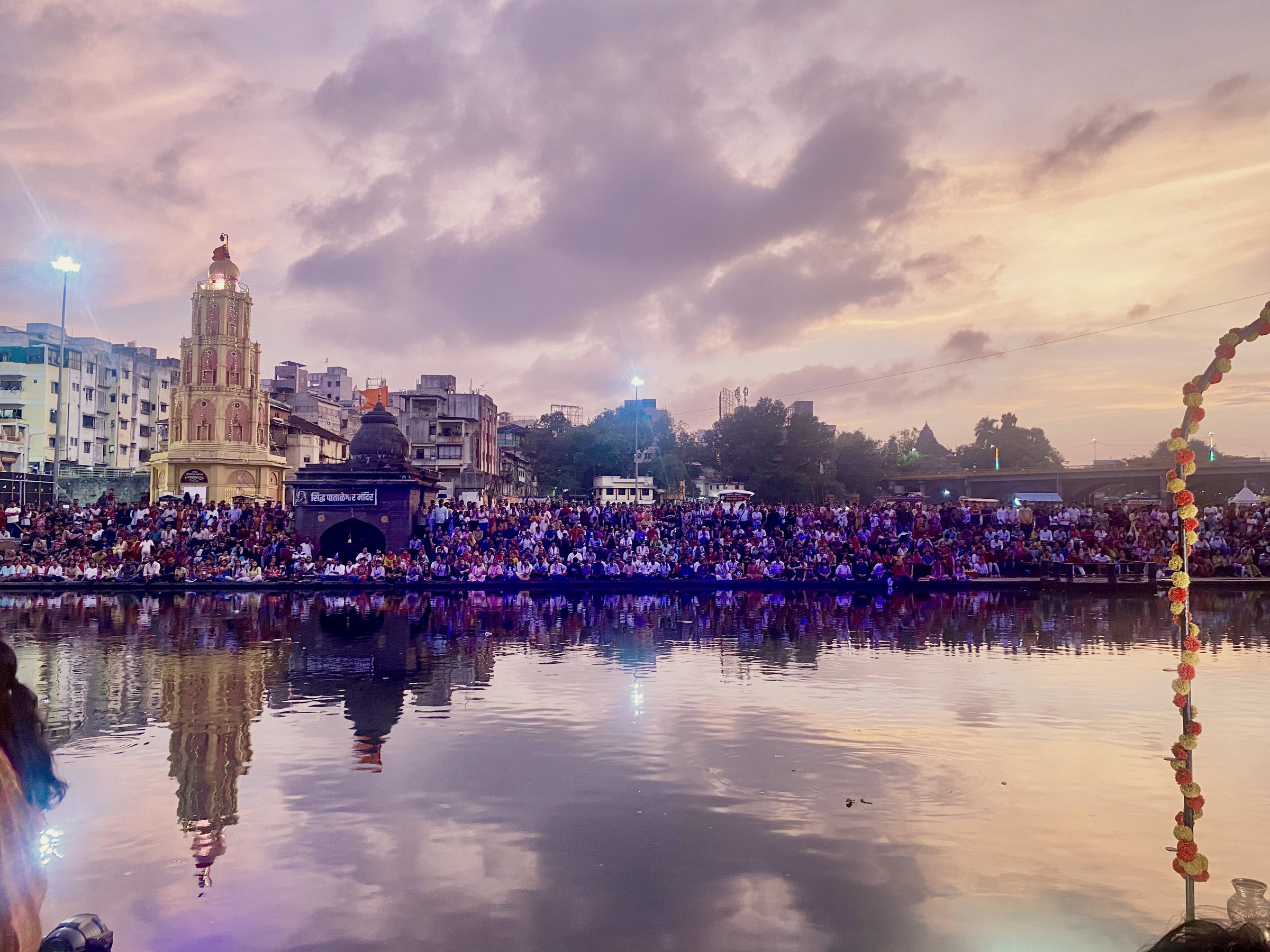 The crowd gathered on the ghat at Ramkund, Nashik, at dusk
